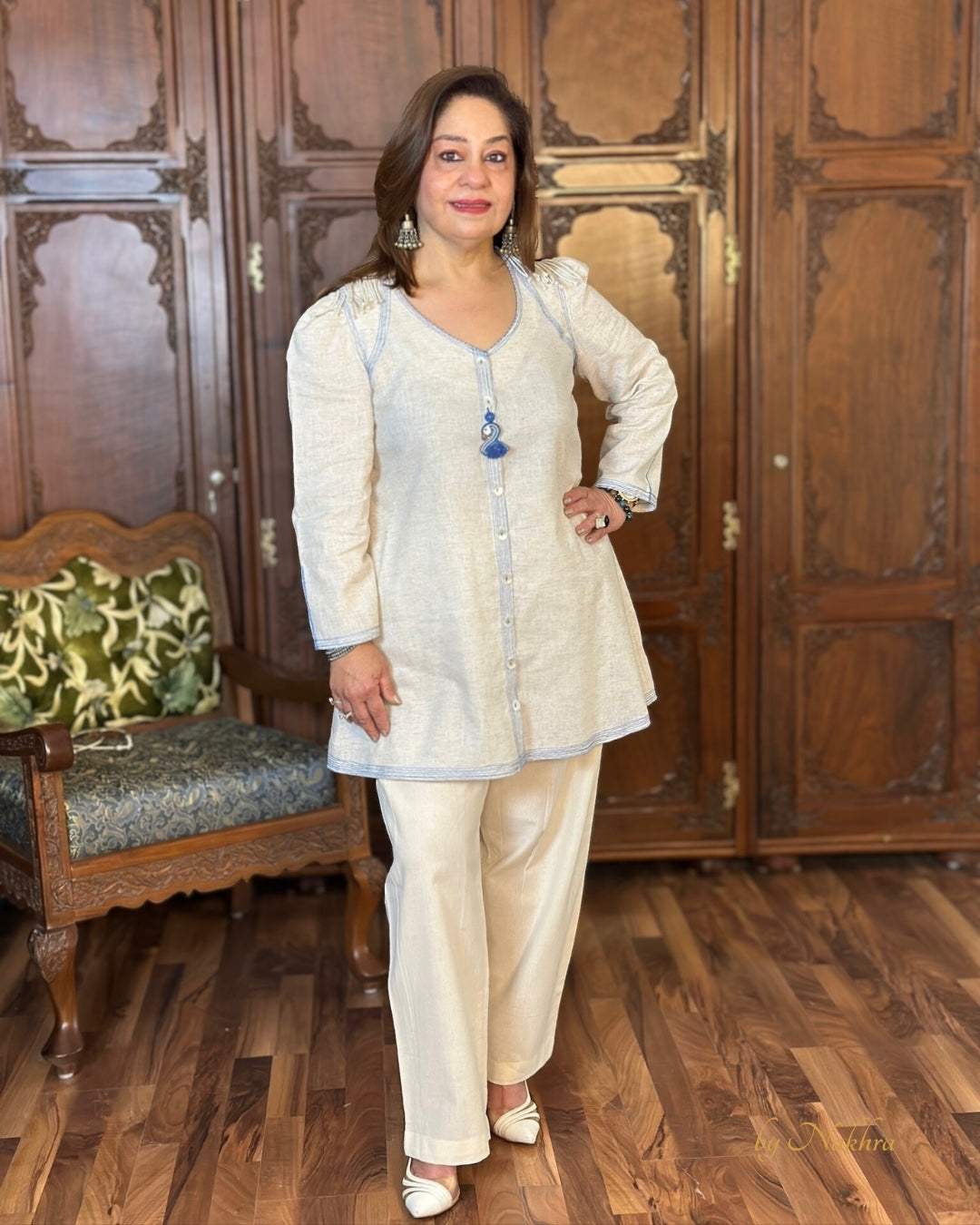 Model wearing First Light ivory khadi co-ord set with royal blue topstitching and puff sleeves