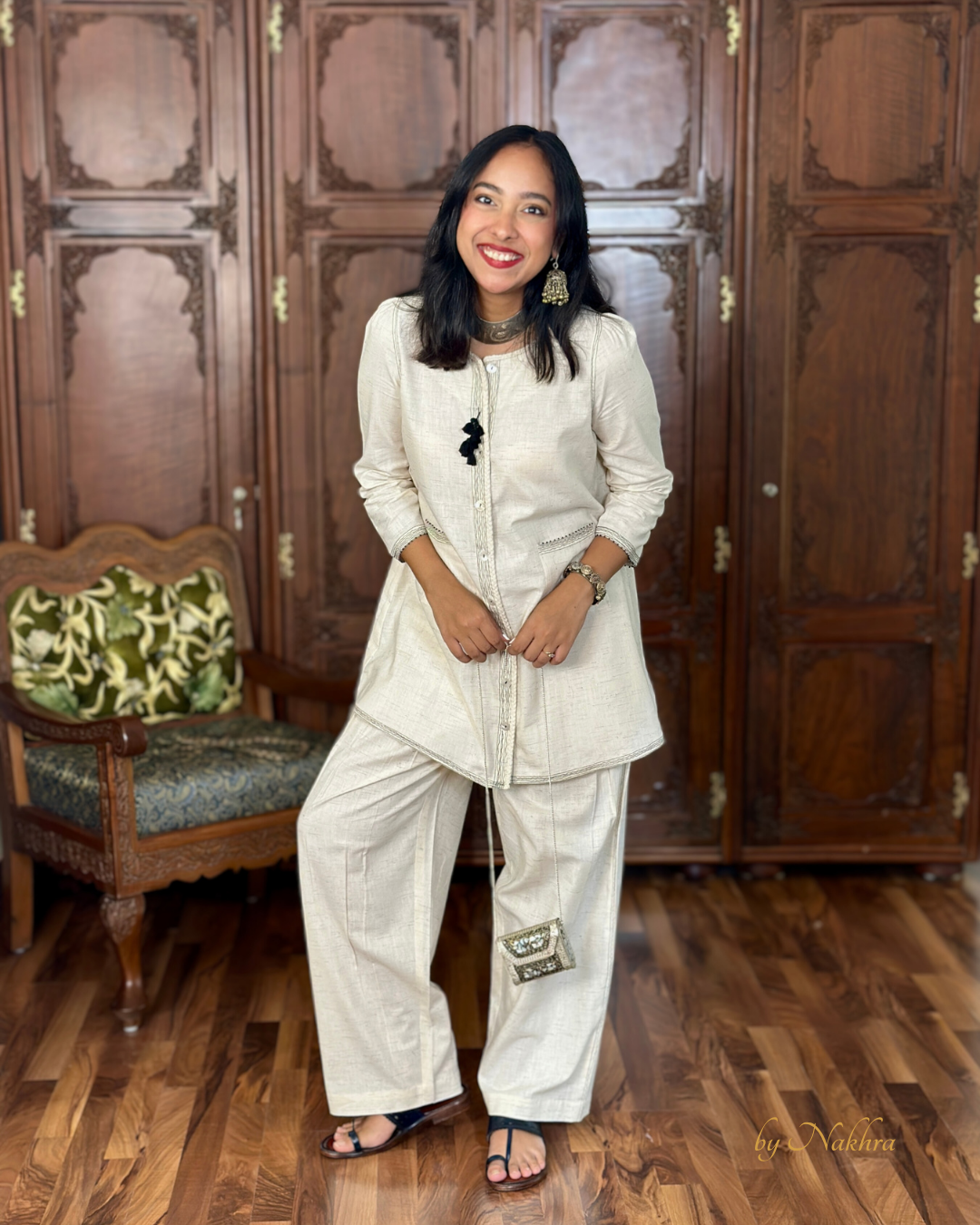 Model posing in relaxed-fit Morning Haze co-ord set made from breathable textured khadi cotton styled with silver jewelry and clutch